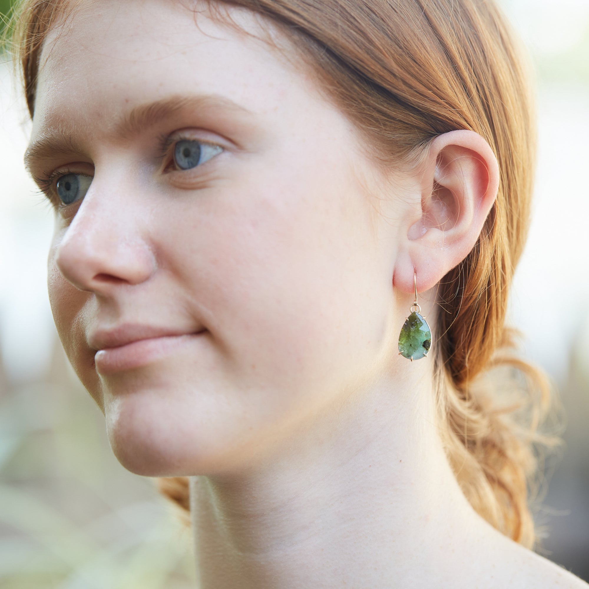 green lacewings tourmaline earrings with prongs on person by hannah blount jewelry