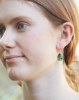 green lacewings tourmaline earrings with prongs on person by hannah blount jewelry