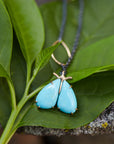 kingman turquoise longtail moth necklace with prongs on leaf by hannah blount jewelry