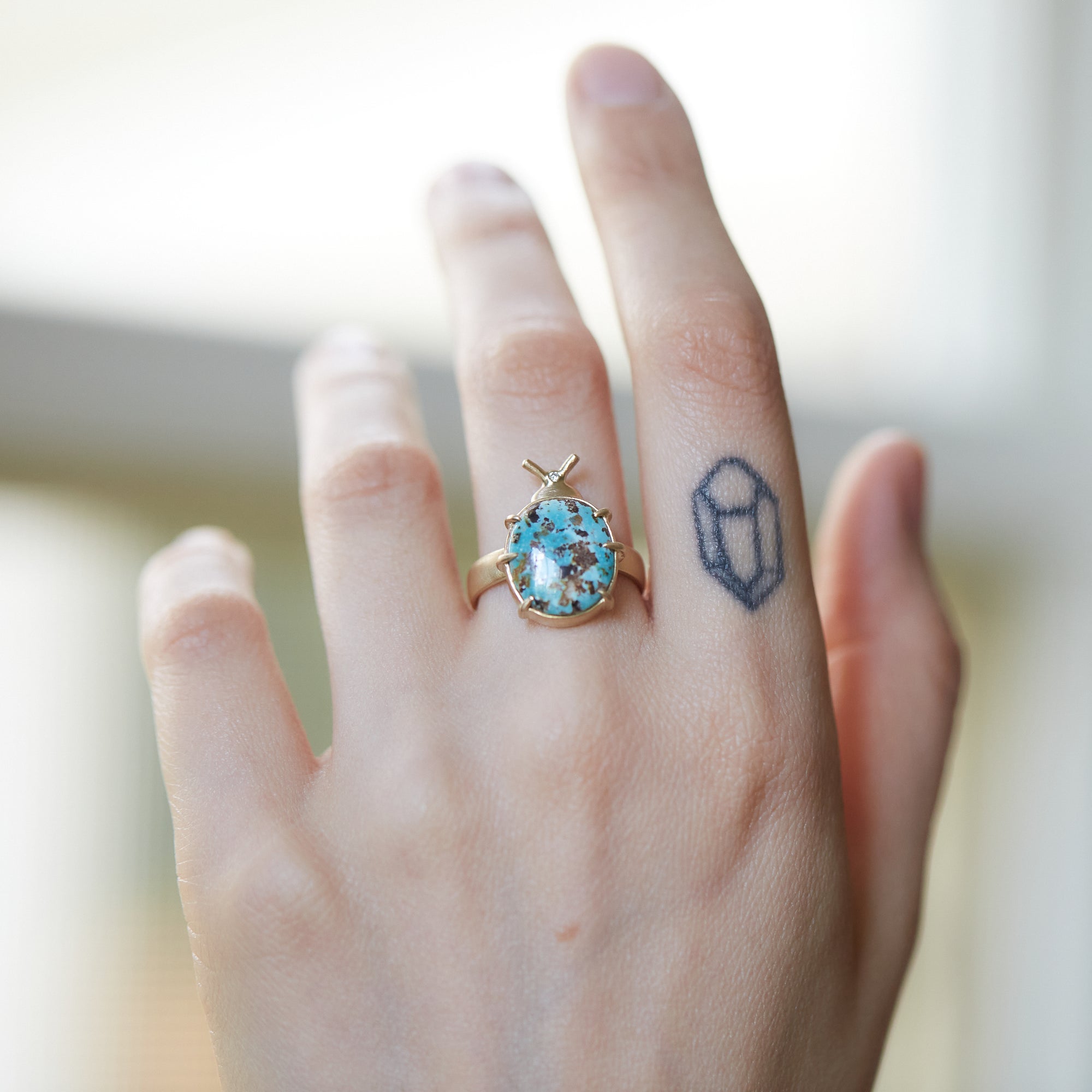 Persian Turquoise with Pyrite Pleasing Beetle Ring on person by Hannah Blount Jewelry