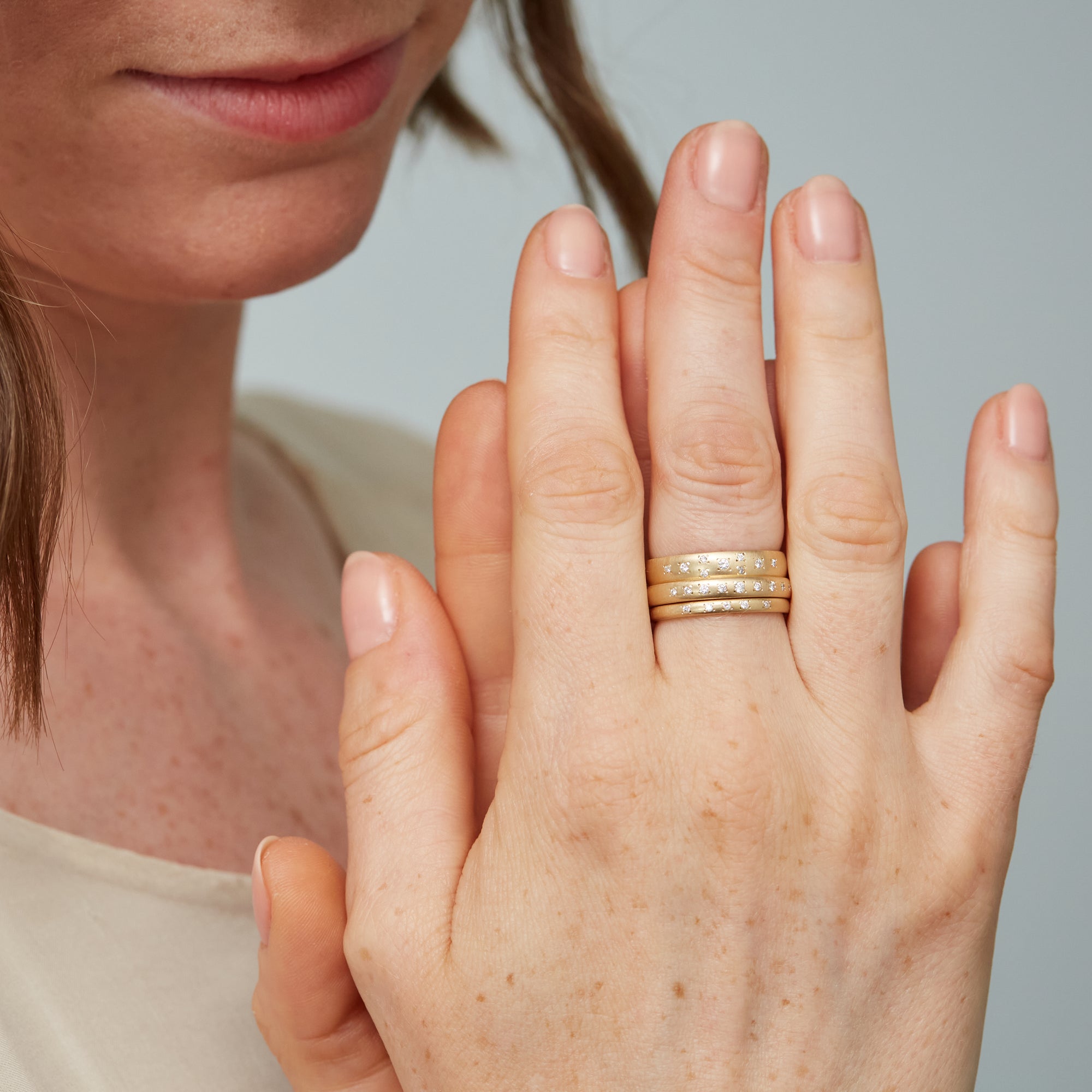 Ovoid gold bands with diamonds by Hannah Blount