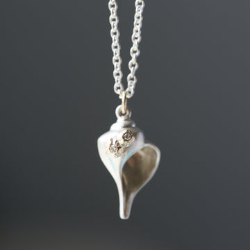 Whelk shell necklace in bright silver with diamond barnacles