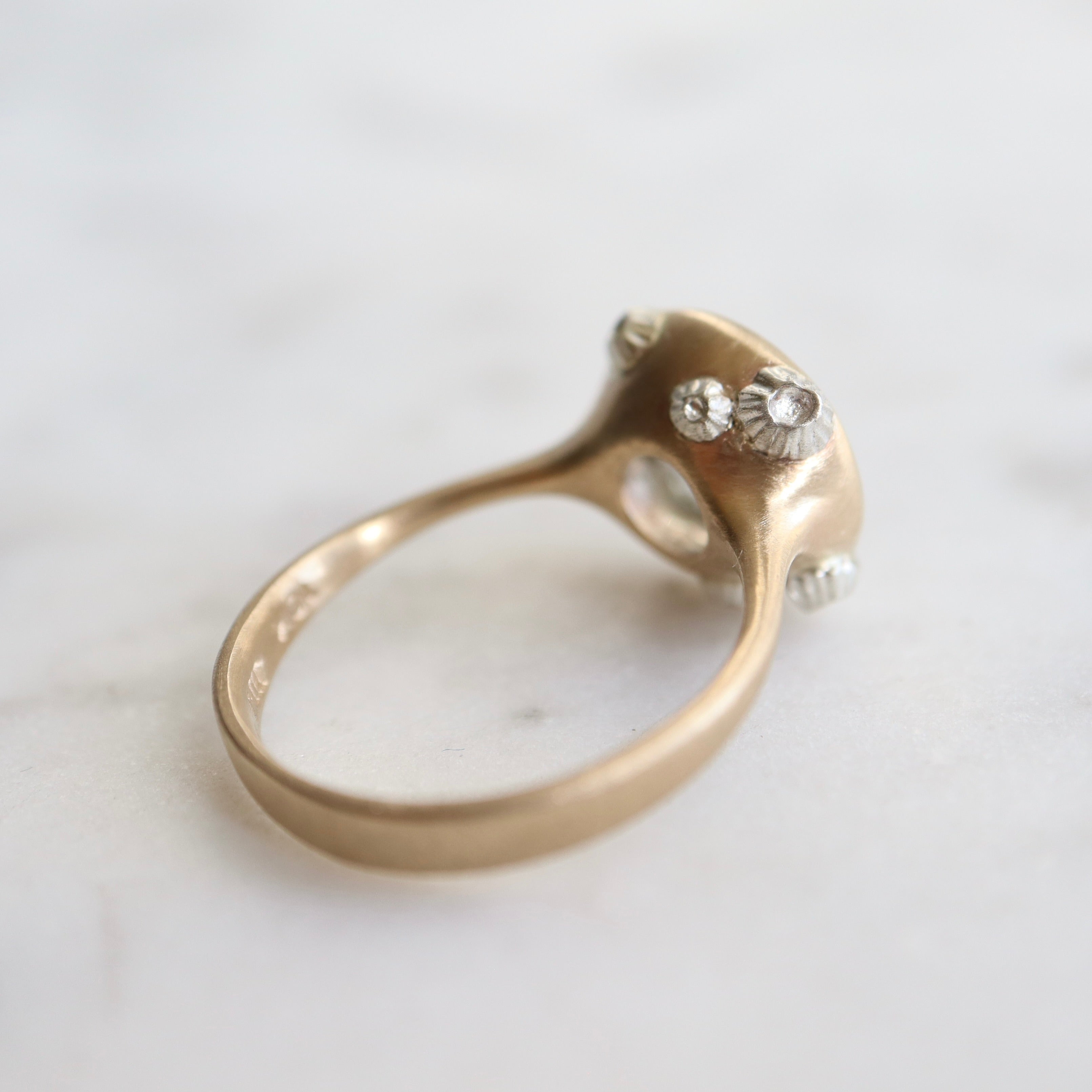 A 2.1ct Aquamarine ring with black inclusions set in a 10k gold band encrusted with silver barnacles. 