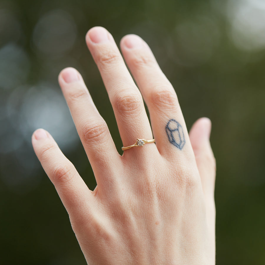 little salt and pepper diamond ring set in gold branches on hand. by hannah blount