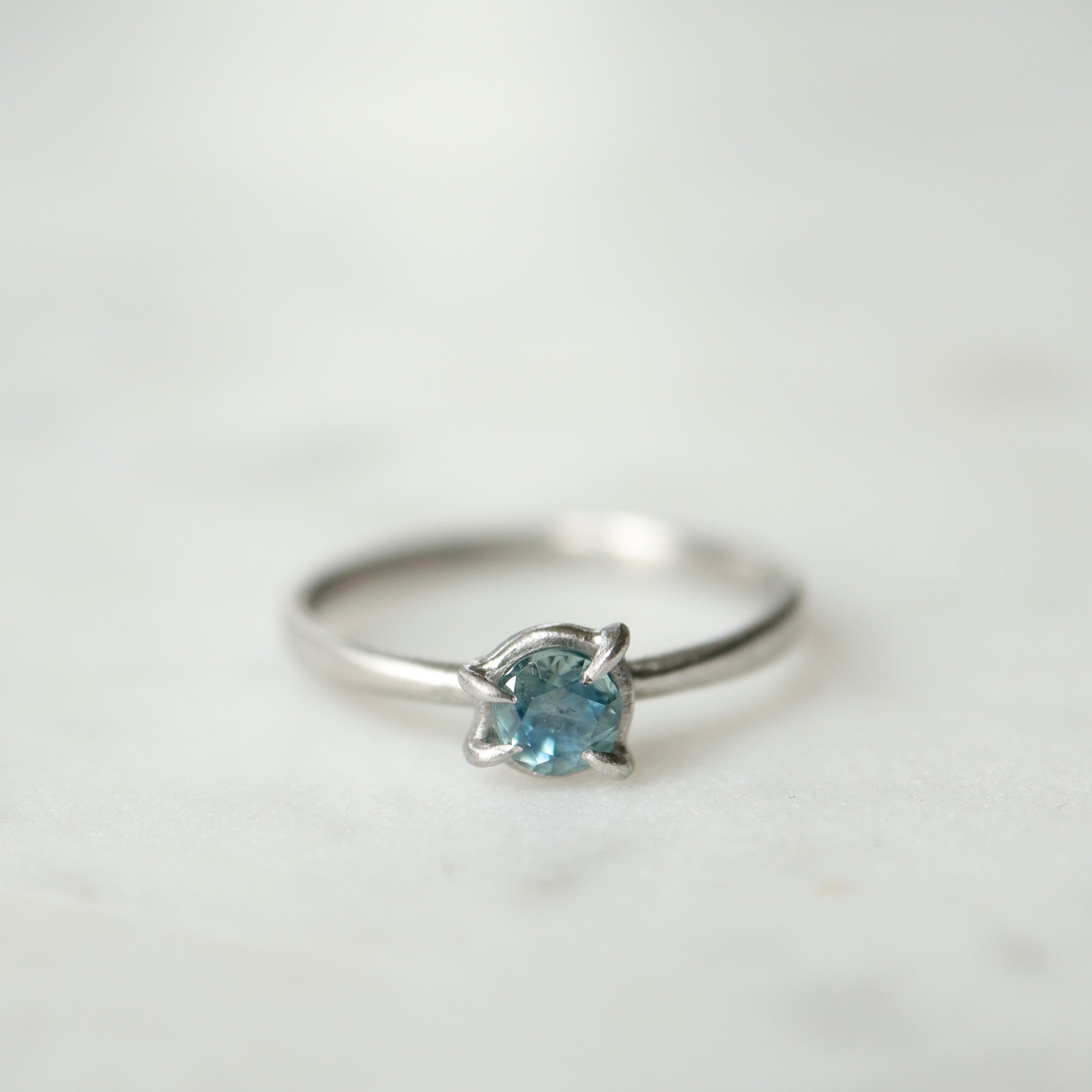 blue montana sapphire stone set in a ring of platinum via prongs.