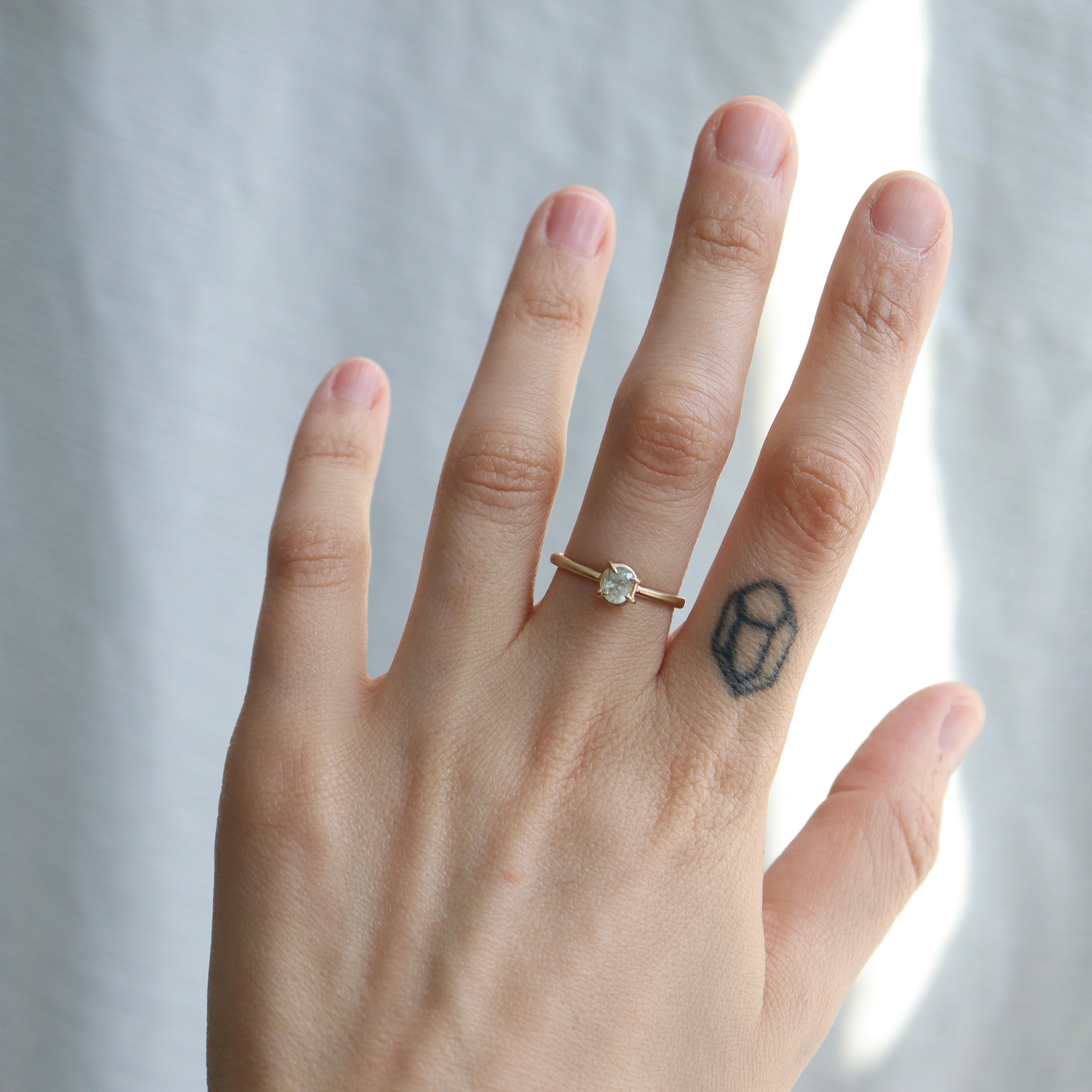 0.56ct Pale blue Montana sapphire Vanity ring set in 14k gold with four prongs, displayed on a hand.