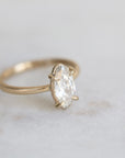 elongated oval diamond set in yellow gold ring with prongs
