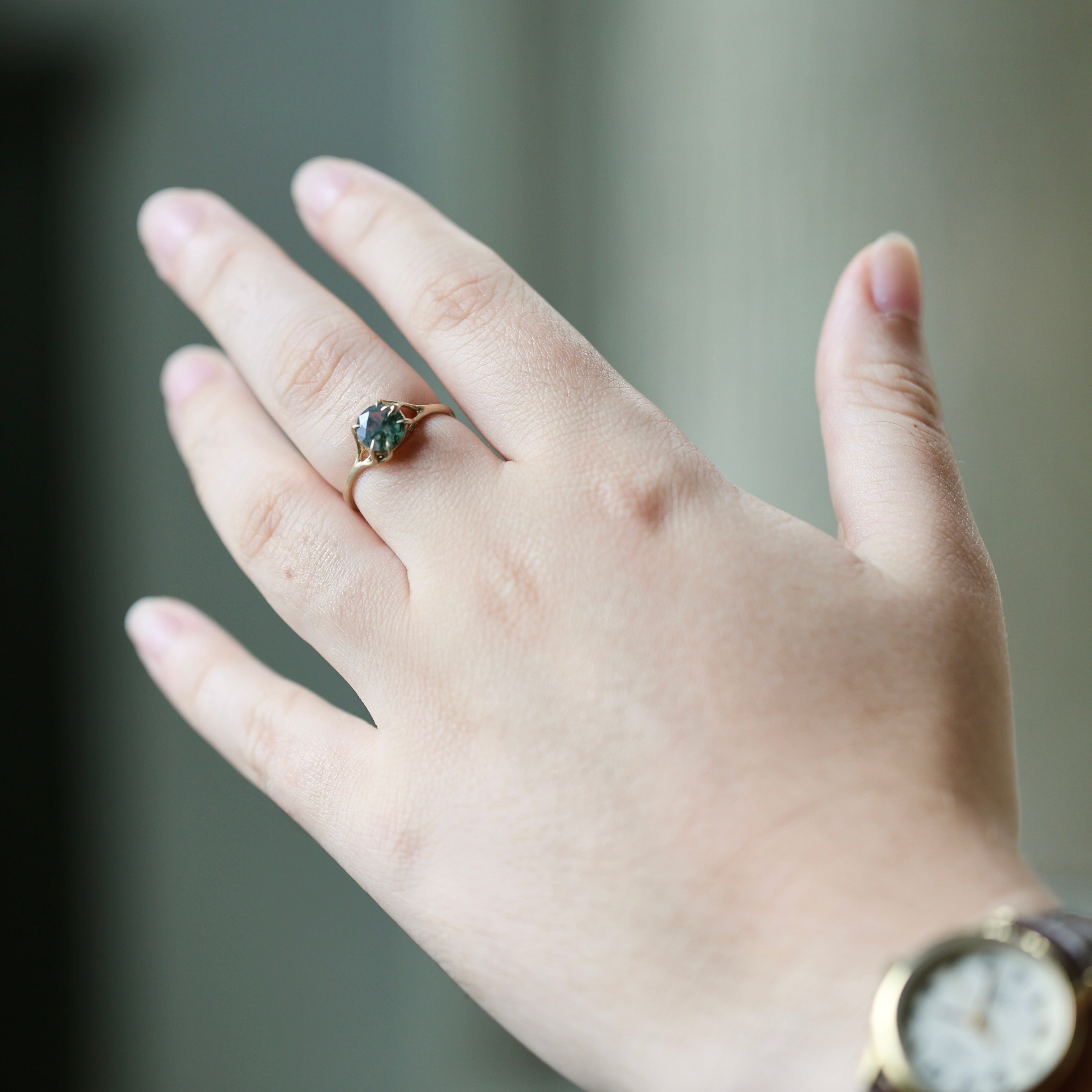 green agate stone set in gold branch ring shown on middle finger