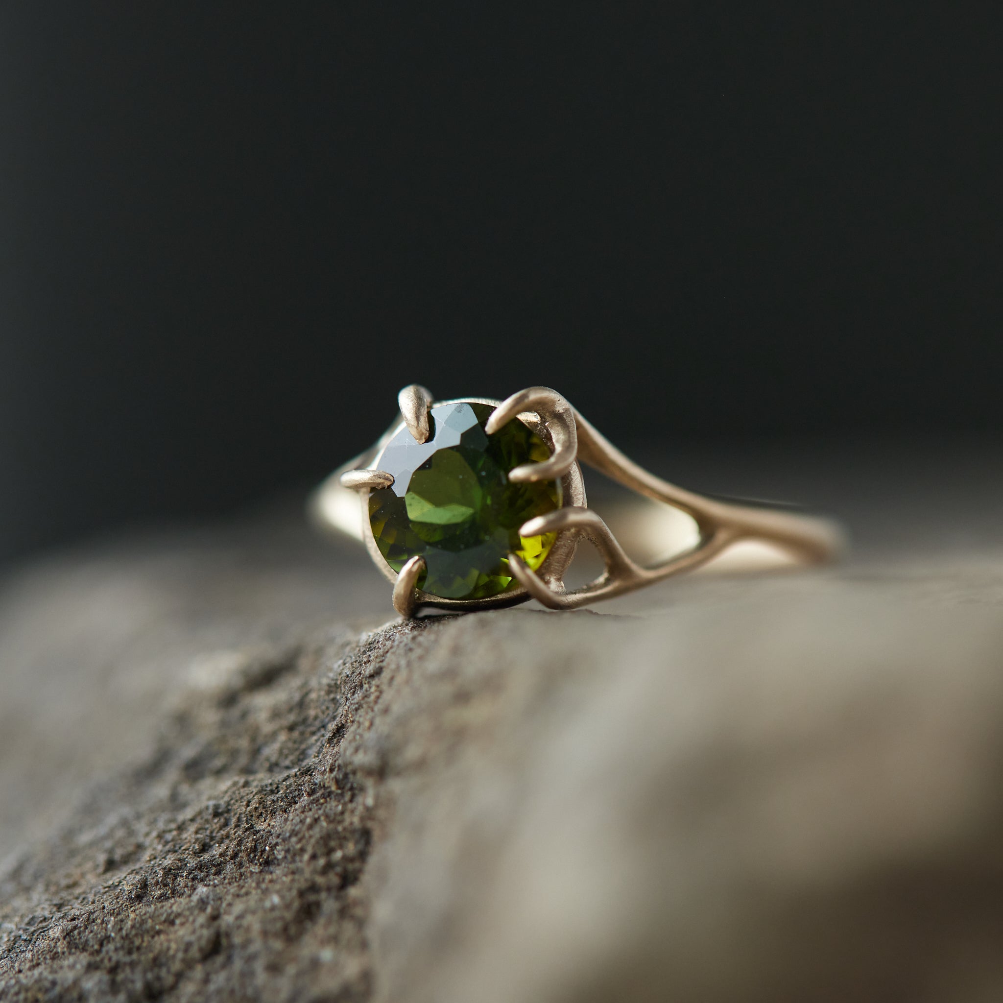 a lush green round tourmaline sits in gold branch prongs in this branch ring. 1/4 view.