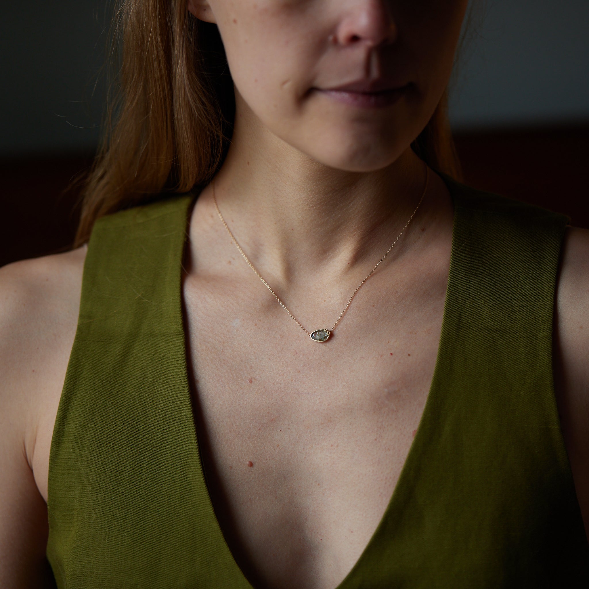 Sapphire necklace with gold barnacle setting on person