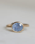 Ring with a blue gemstone on a light gray background