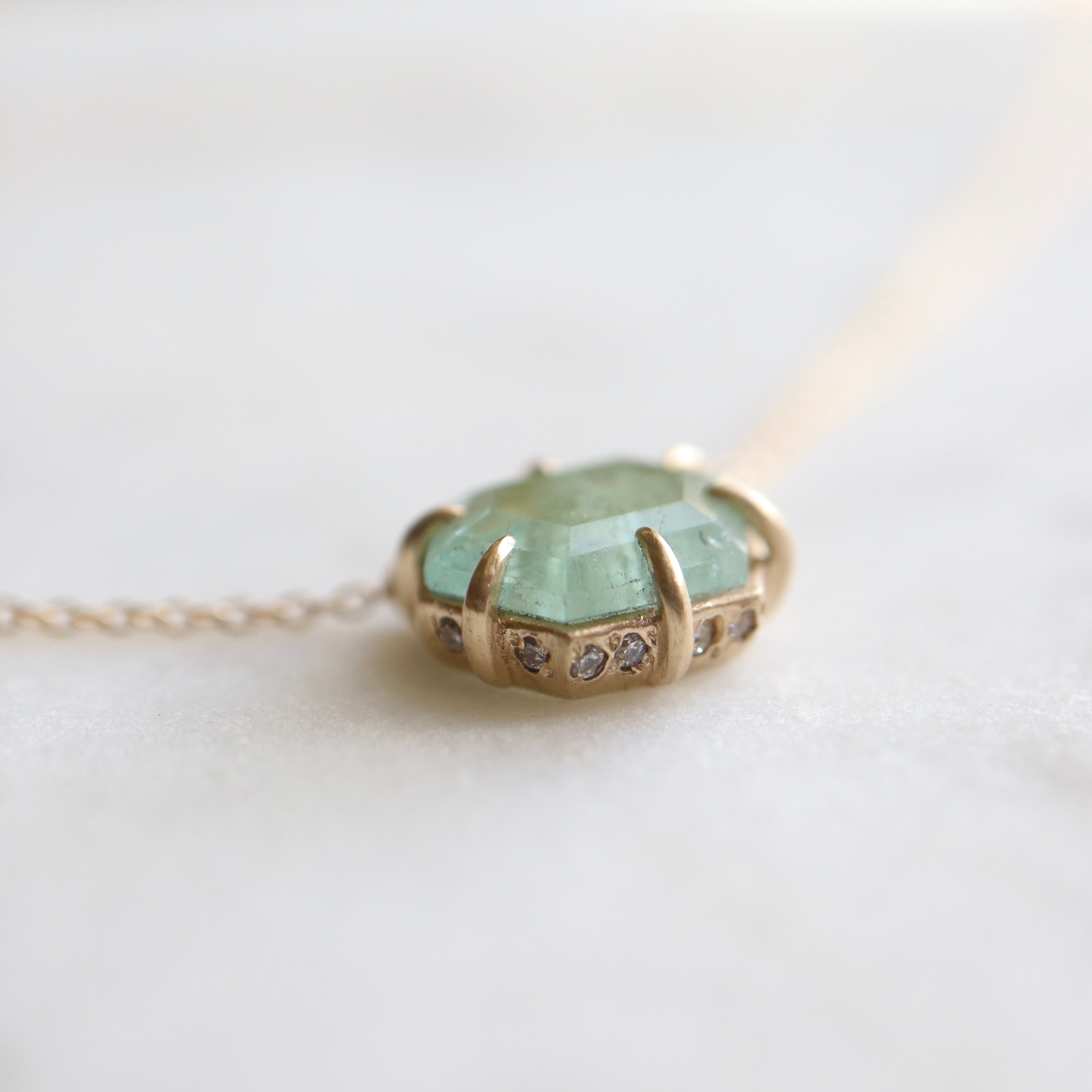 hexagon mint emerald necklace with diamonds set in the side, in gold