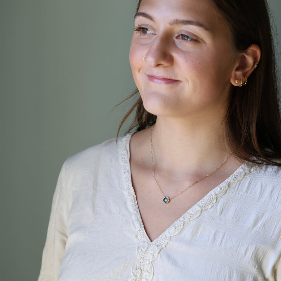 woman wearing white blouse and gold necklace