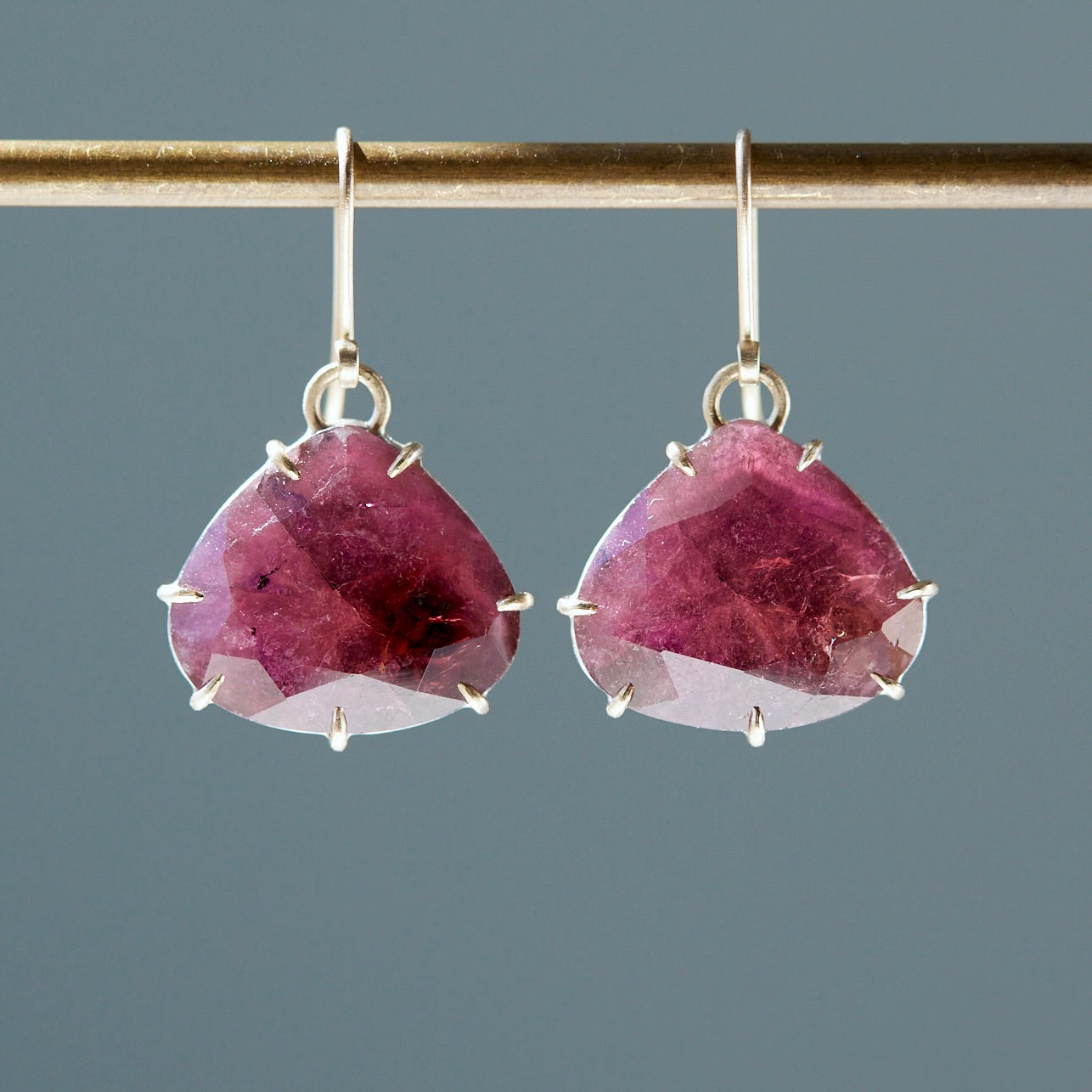 Teardrop berry tourmaline gemstones are set in gold prong with gold ear wires