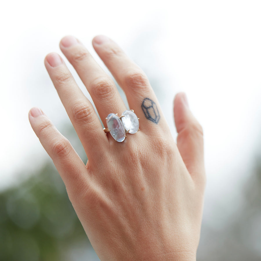 double blue stone ring set in gold by hannah blount on person