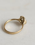 Gold ring with a gold sapphire on a light gray background