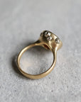 Gold ring with white gold barnacles on a gray surface