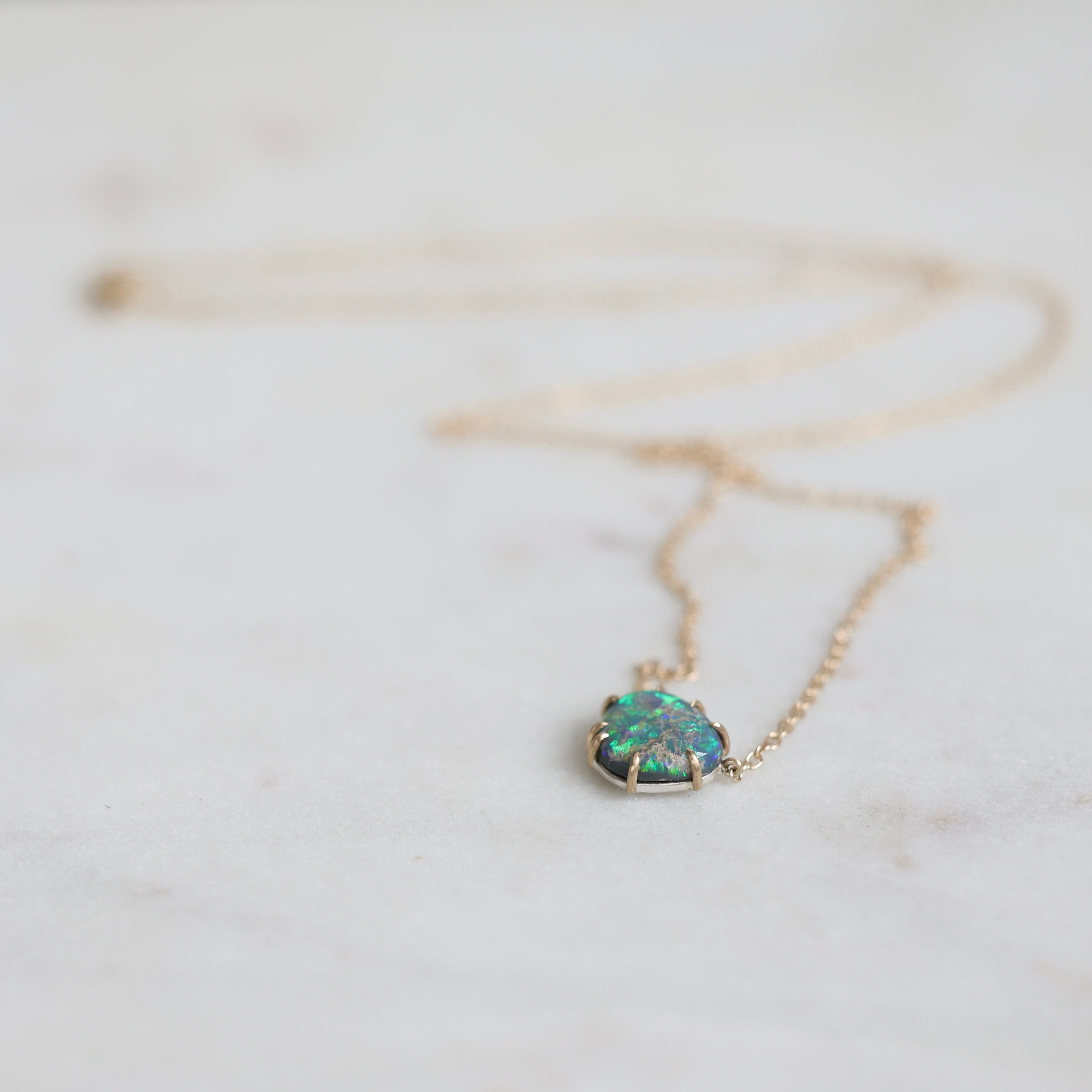 Necklace with an opal pendant on a light background