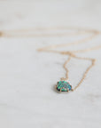 Necklace with an opal pendant on a light background