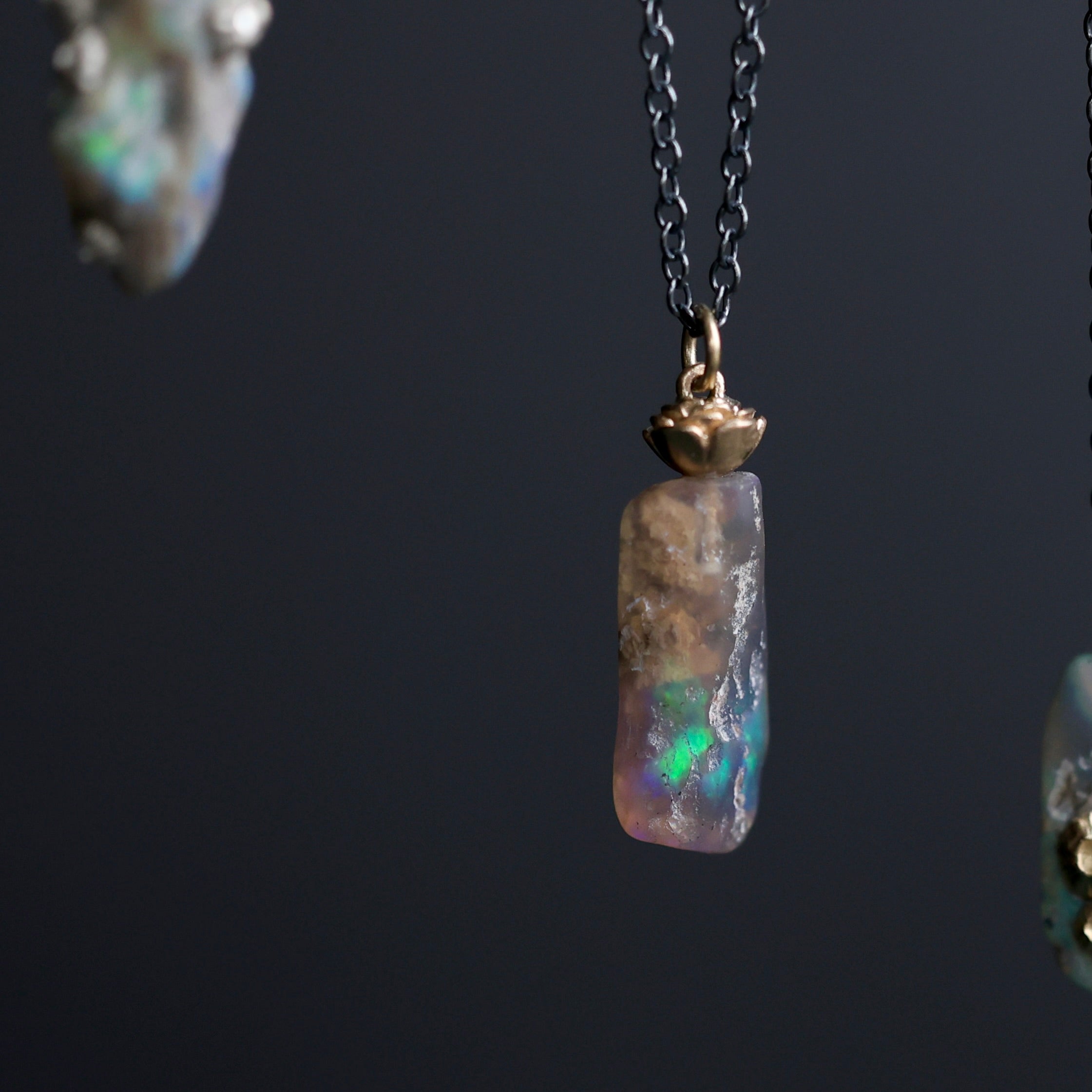 Opal pendant necklace on a dark background