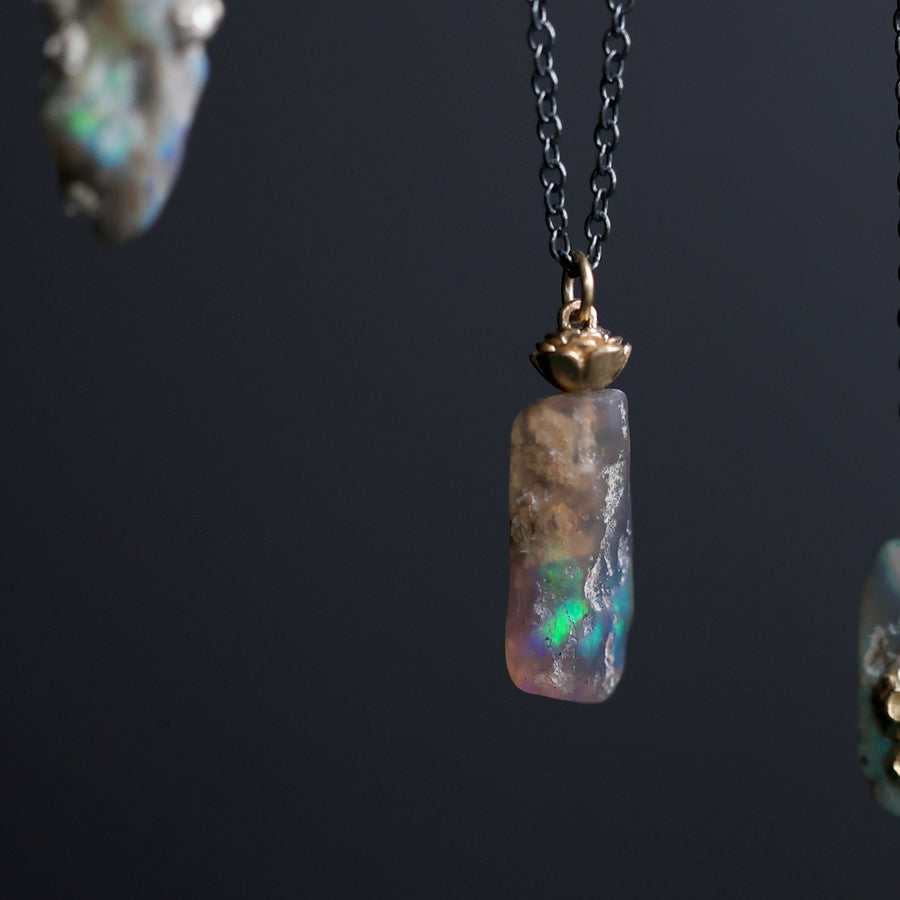 Opal pendant necklace on a dark background