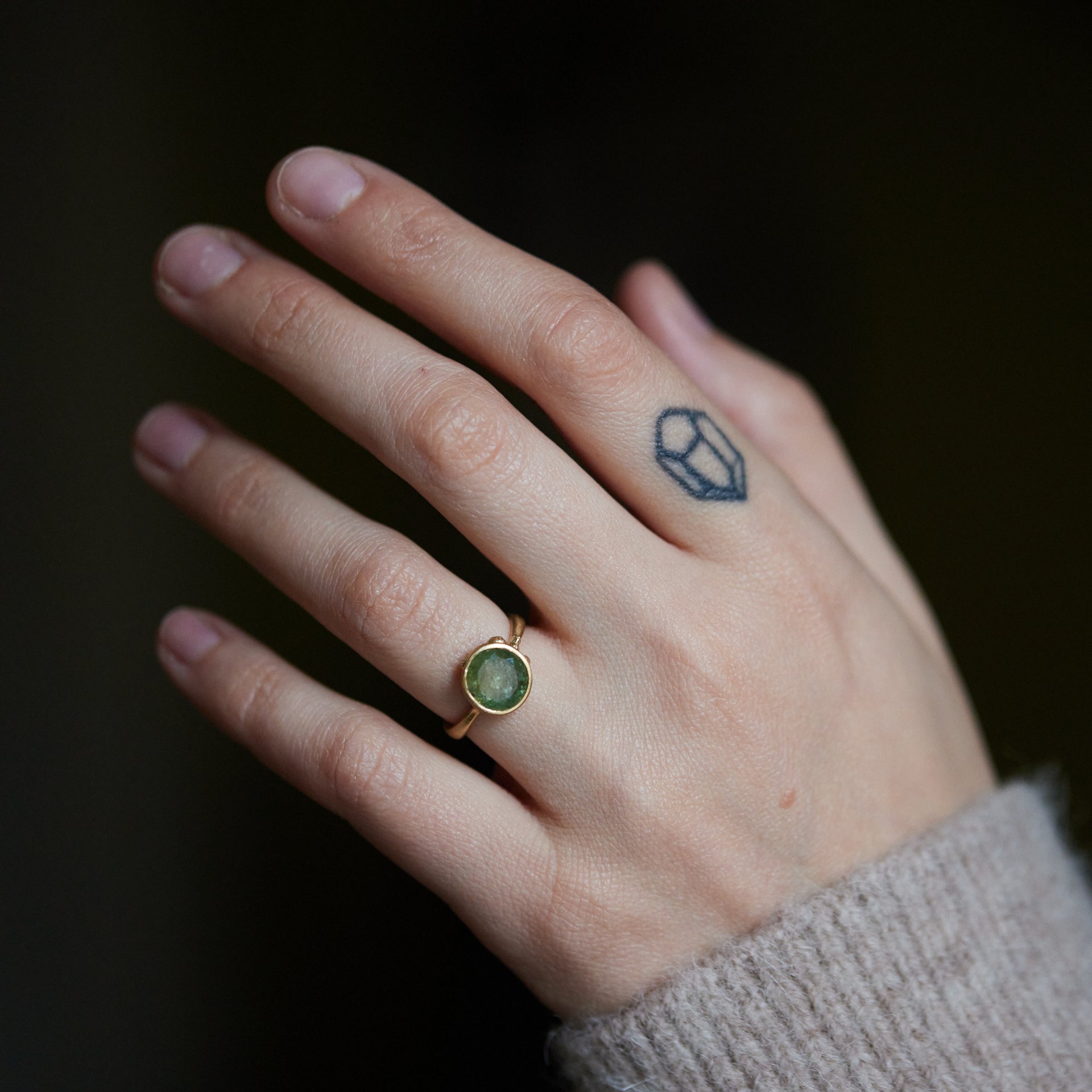 green montana sapphire ring on person