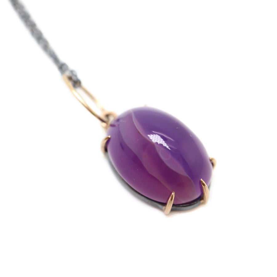 detail of purple chalcedony necklace with gold prongs by hannah blount