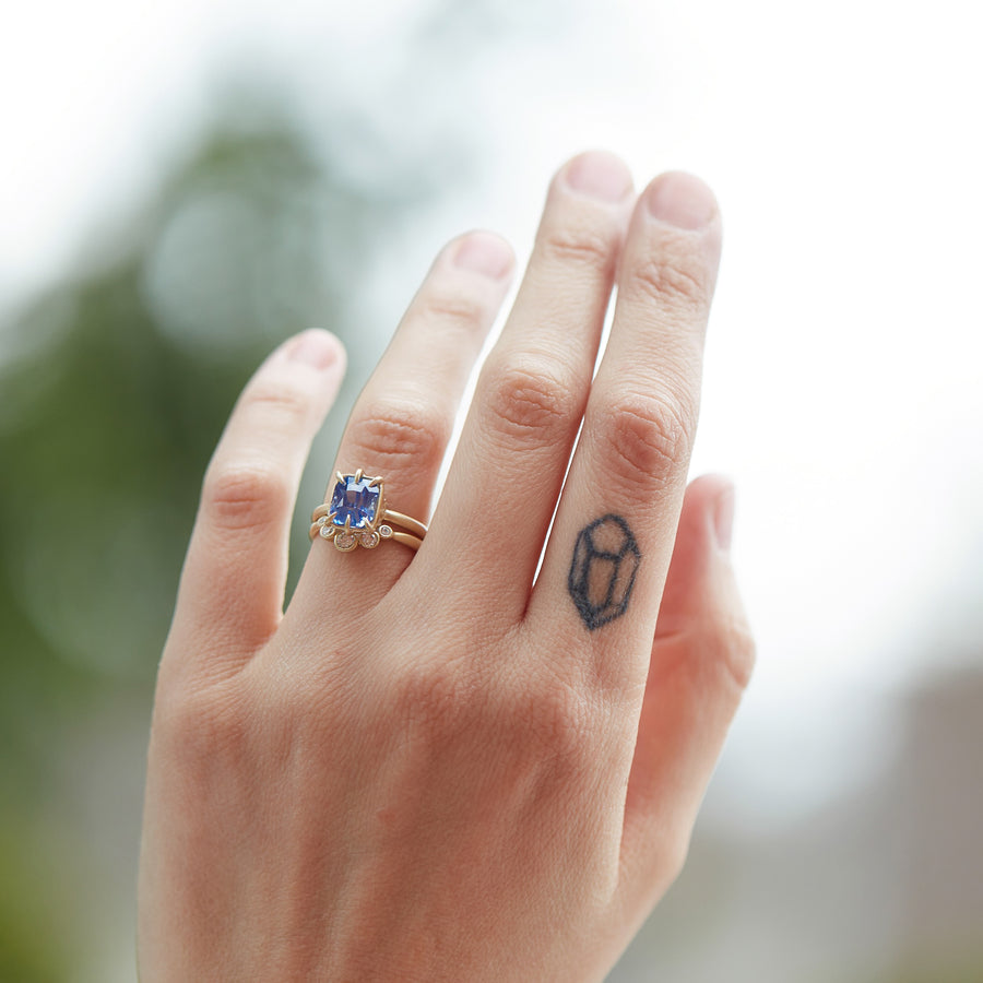 Sapphire vanity ring in gold with tidal moon band on hand