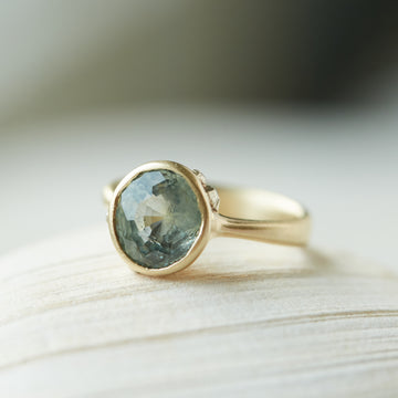 Sapphire in gold band with barnacles and diamonds by Hannah Blount