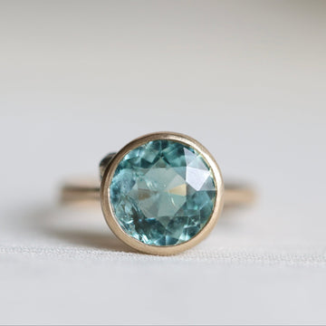 Ring with a blue gemstone on a light background