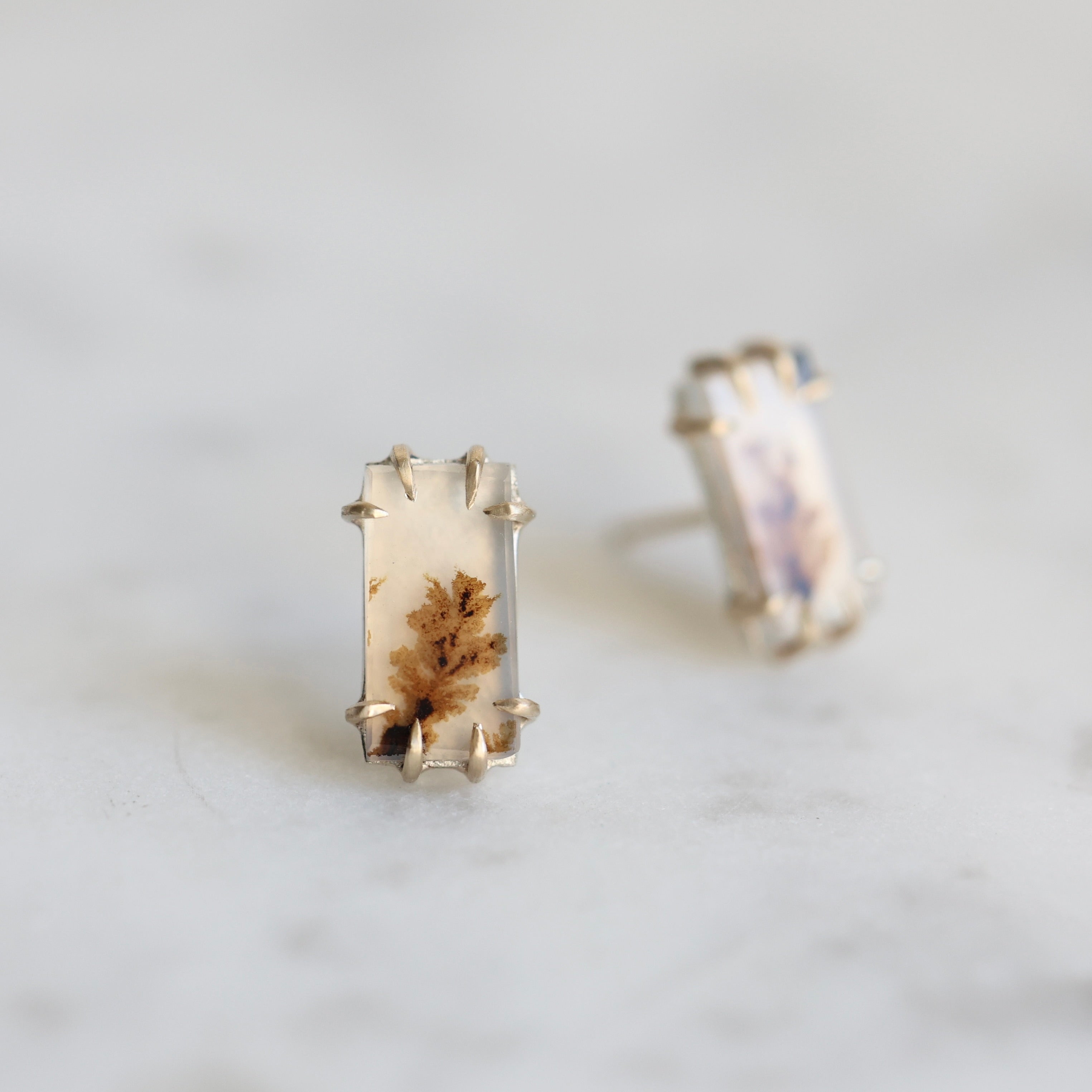 Rectangular earrings with a natural stone design on a light gray background