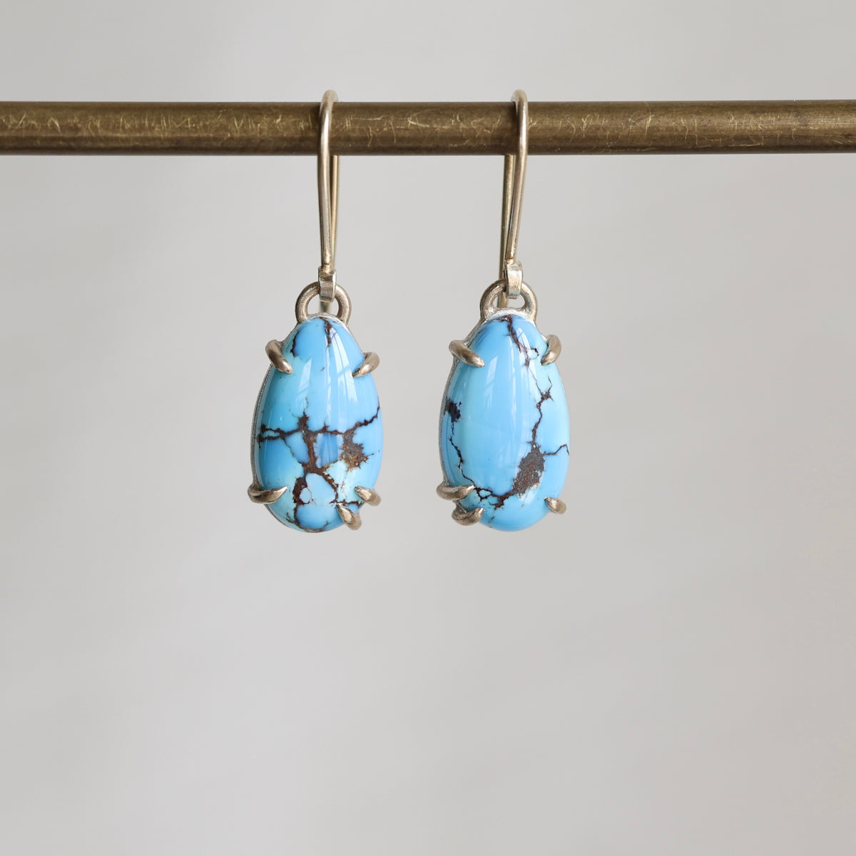 Turquoise earrings on a gray background