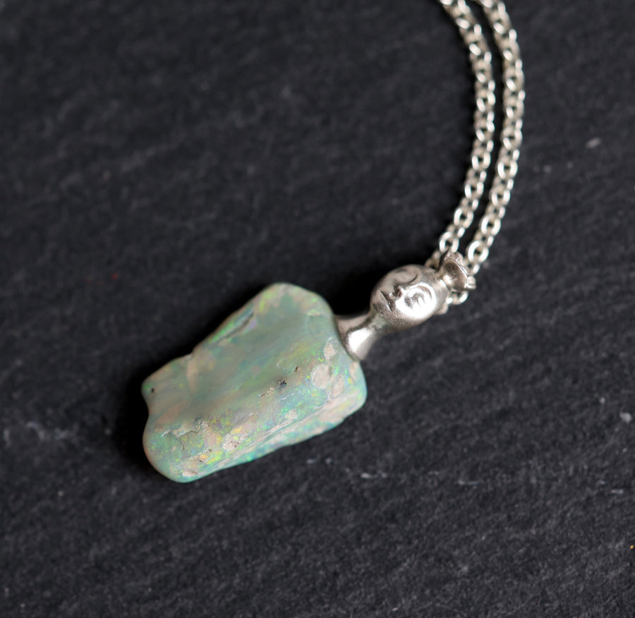 Necklace with an opal pendant on a black background