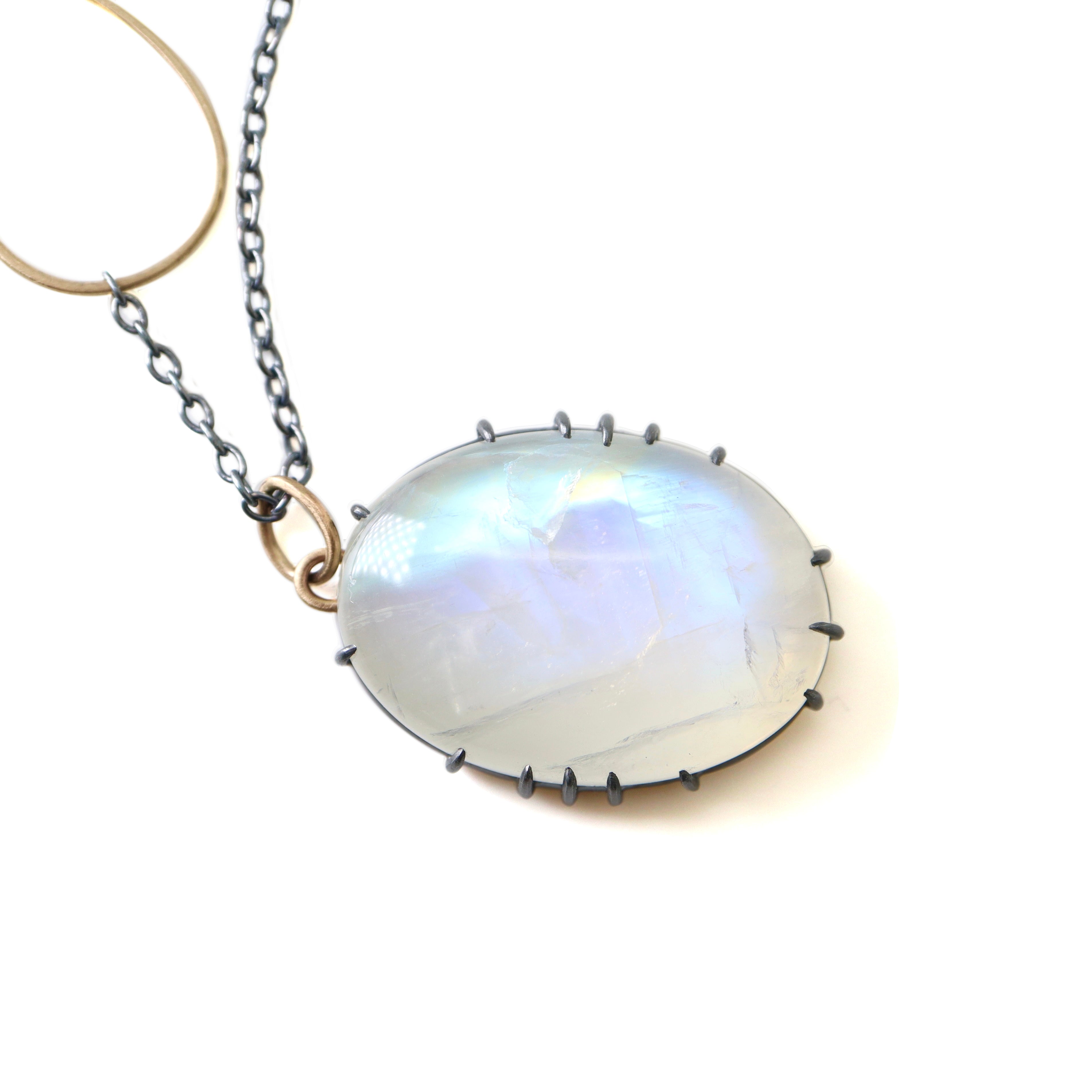detail of rainbow moonstone necklace with oxidized silver prongs by hannah blount