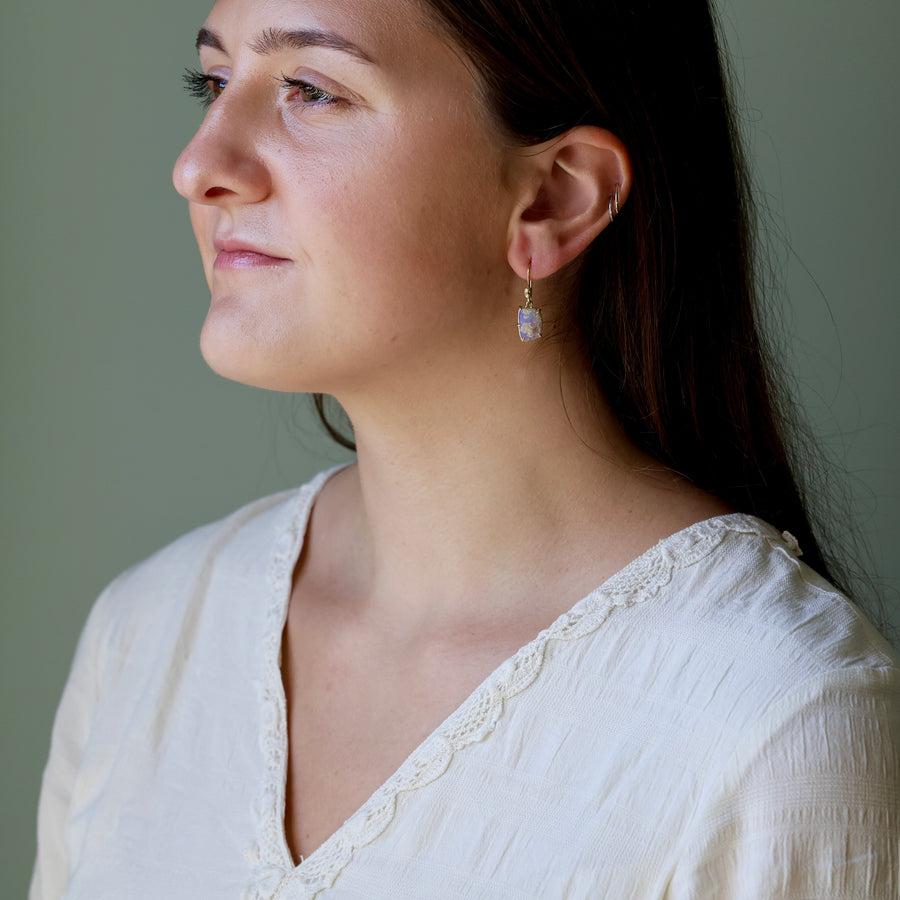 Woman wearing a white top with a neutral background