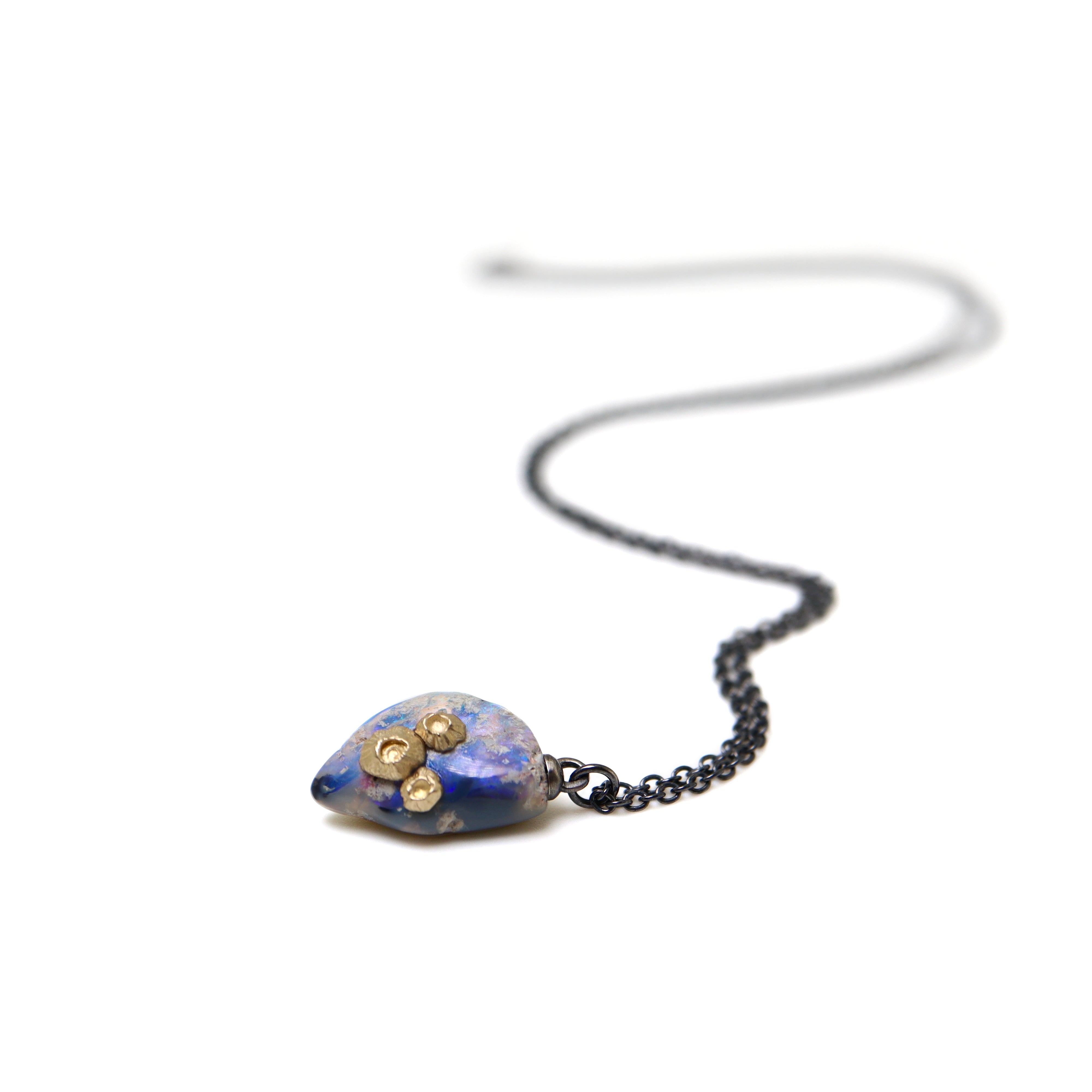 Raw opal with gold barnacles by Hannah Blount