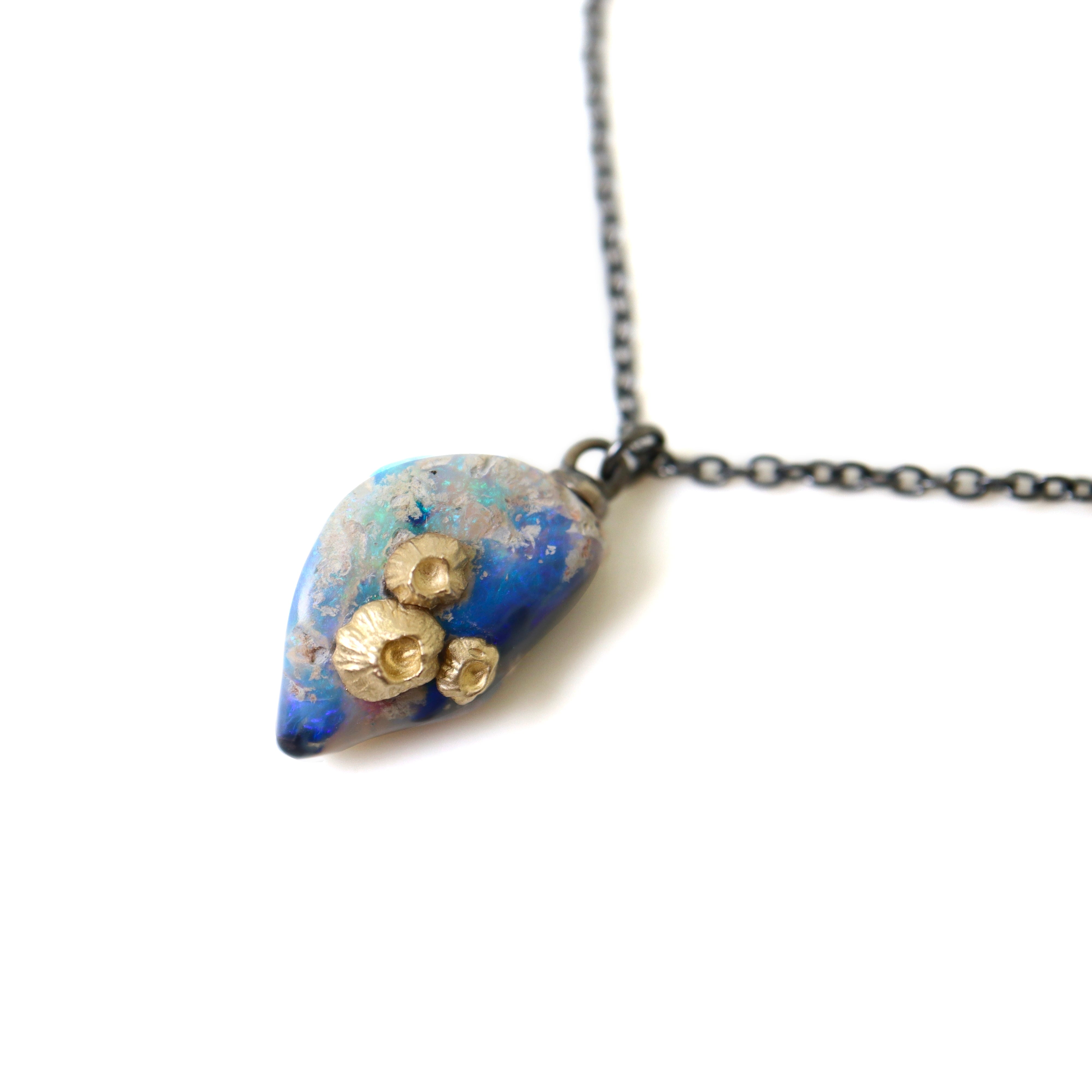 Raw opal with gold barnacles by Hannah Blount