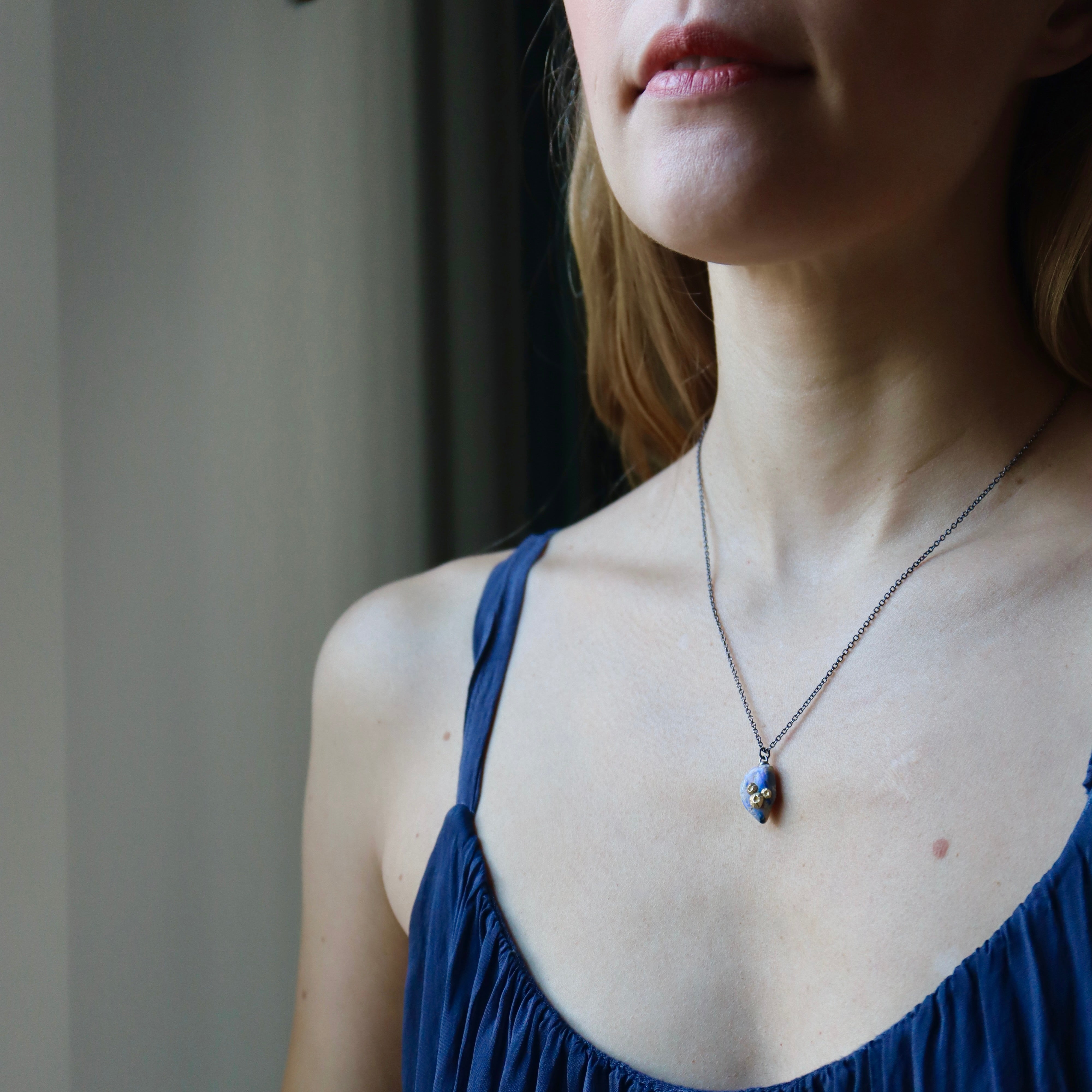 Raw opal with gold barnacles by Hannah Blount