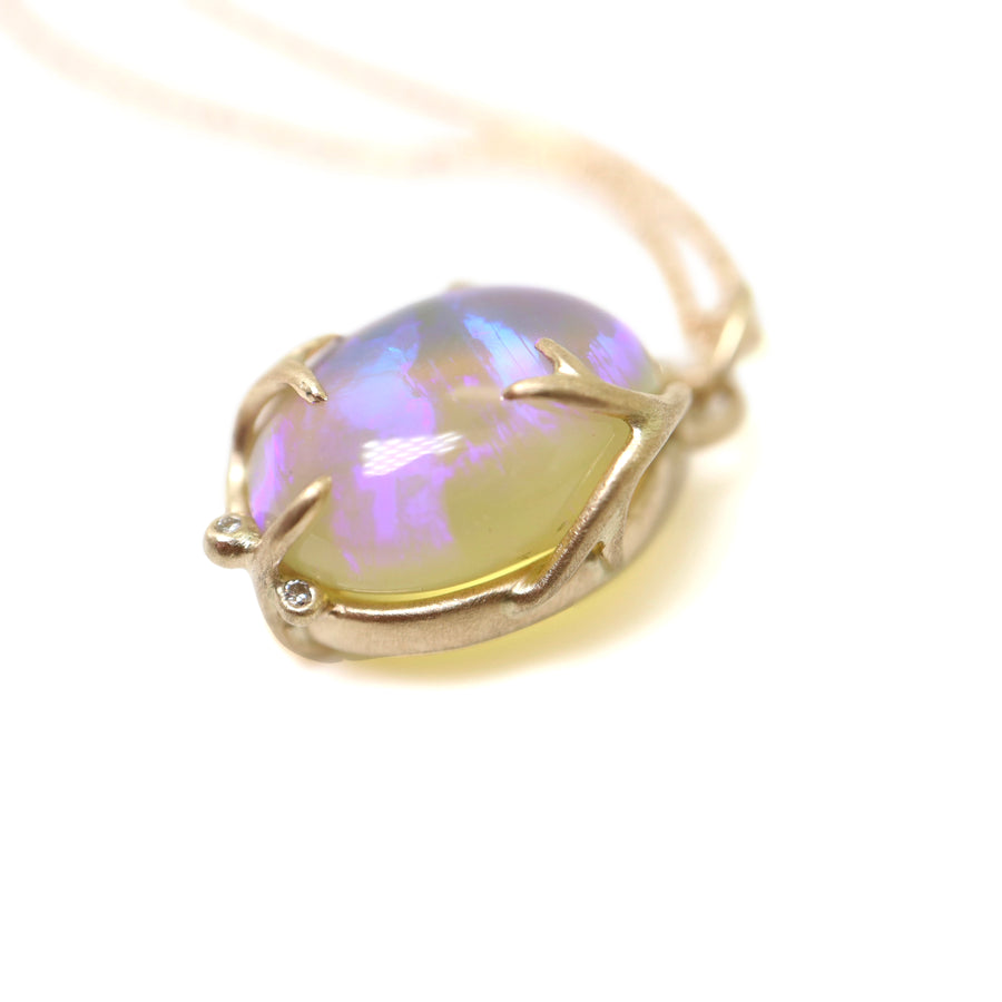 Oval opal with purple and green colors grasped in gold branches with diamonds berries, pendant on gold chain by hannah blount