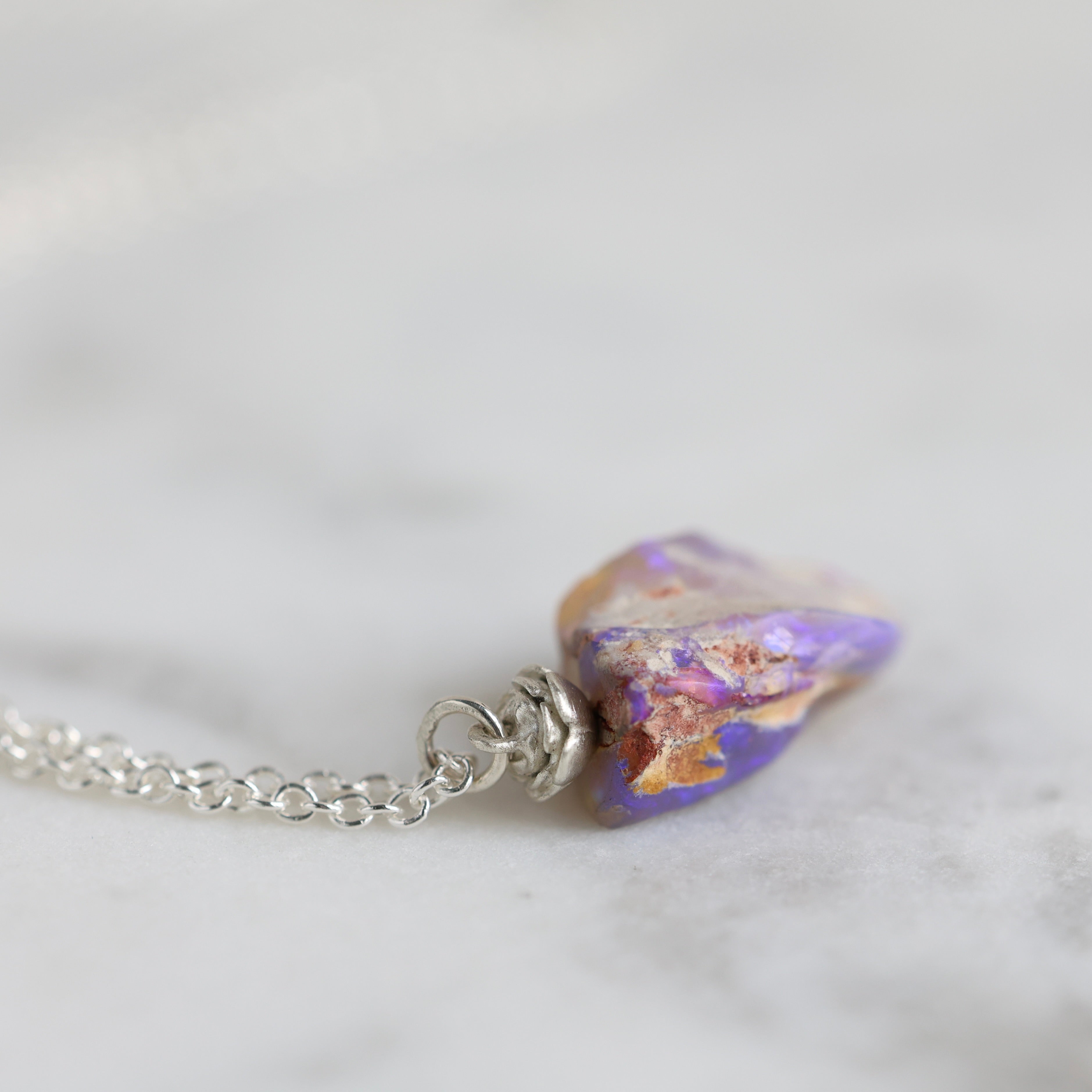 6.35ct opalized wood fossil pendant with a bright sterling silver rose accent and chain.