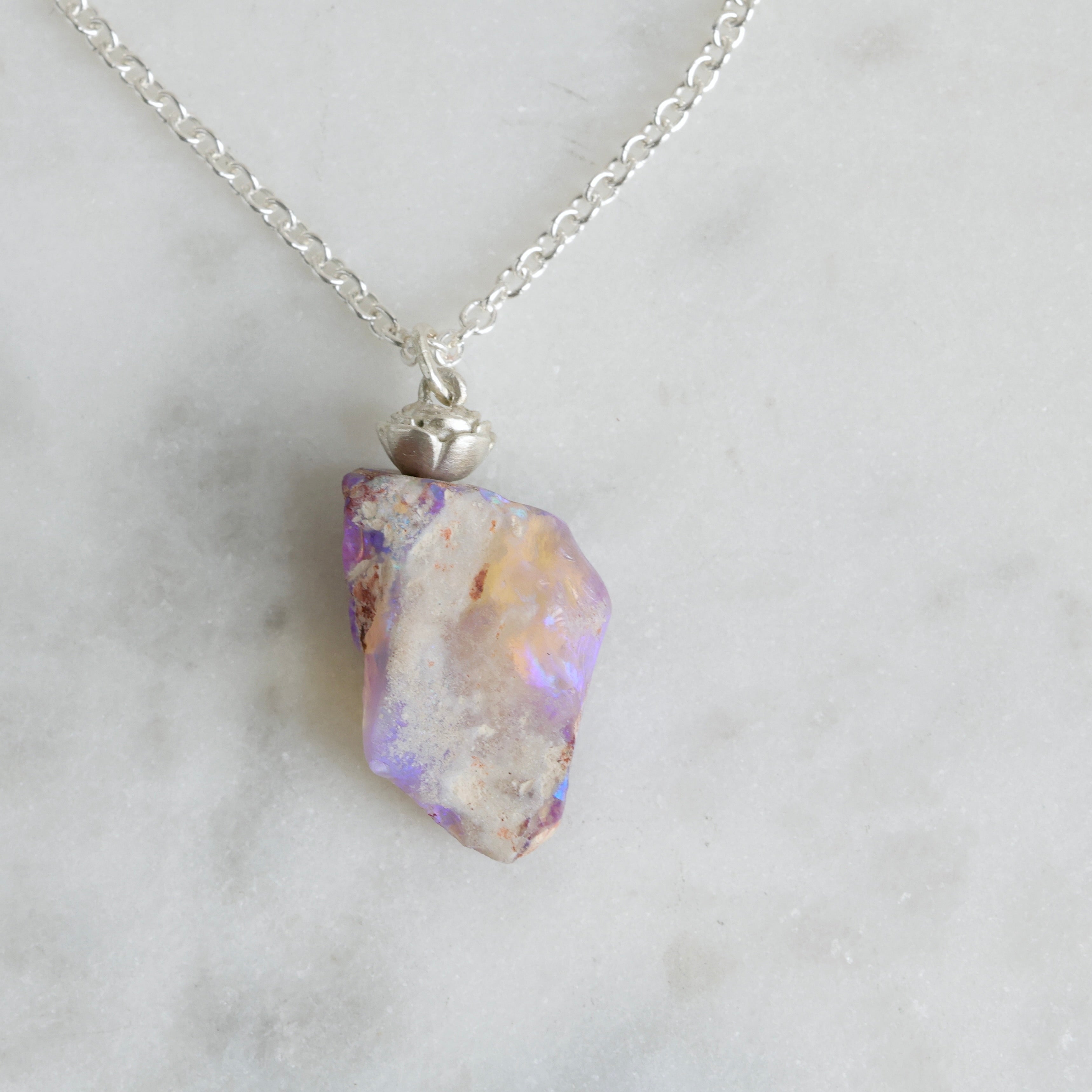6.35ct opalized wood fossil pendant with a bright sterling silver rose accent and chain.