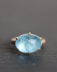 blue stone ring on a dark grey background
