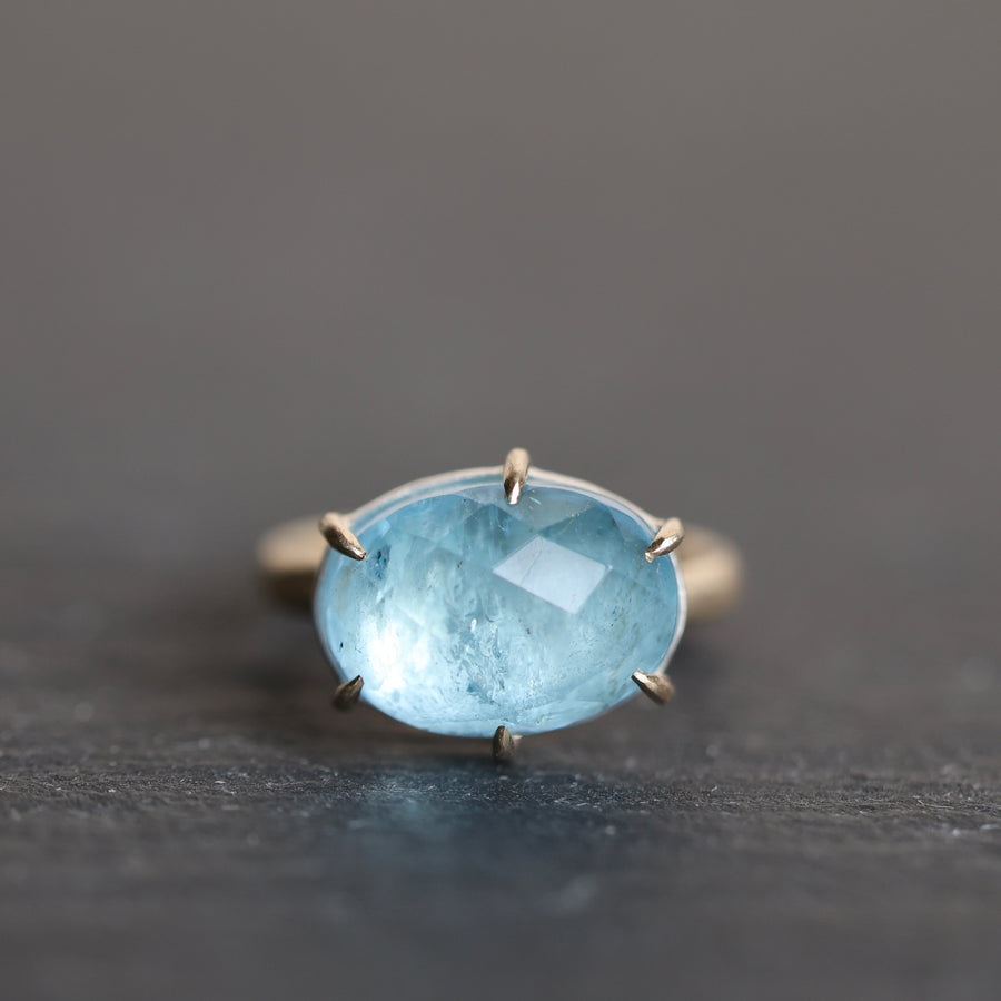blue stone ring on a dark grey background
