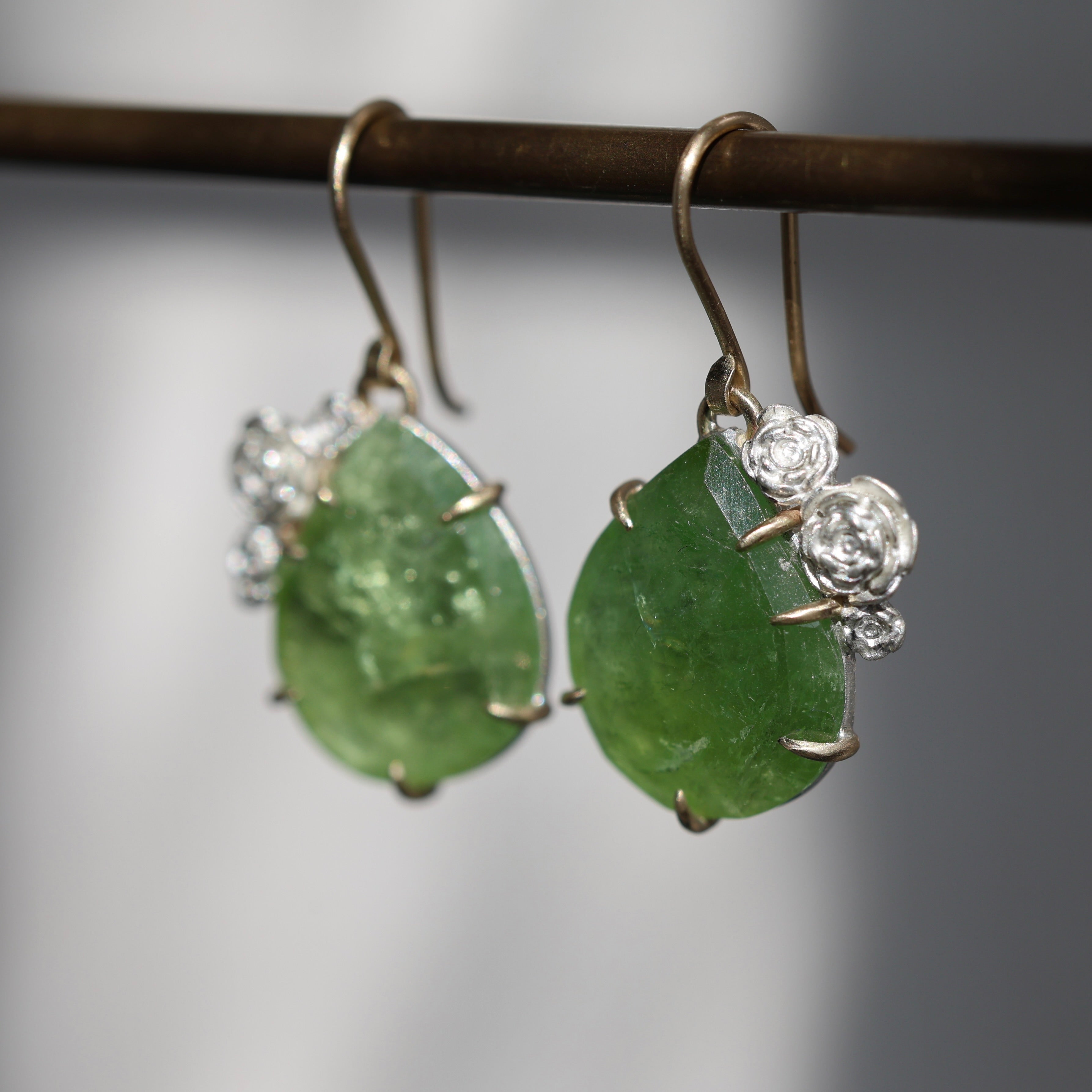Bright green Tourmaline earrings with 14k yellow gold prongs and ear wires and bright sterling silver rose accents and stone seats.