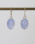 Pair of blue scarab earrings on a white background