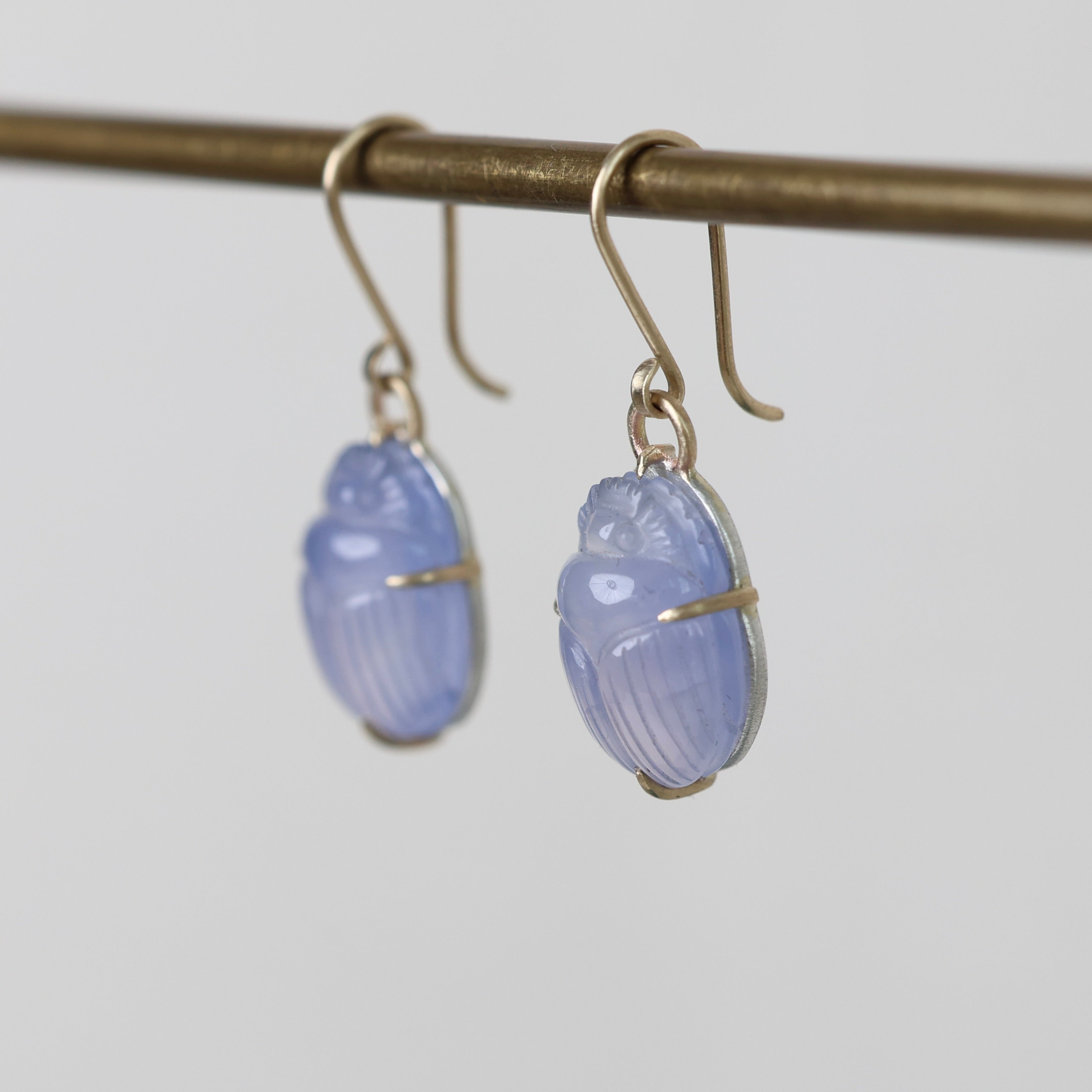 Pair of blue earrings on a gray background