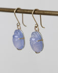 Pair of blue earrings on a gray background
