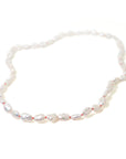 Baroque white freshwater pearl Ruthie B. necklace with coral-hued silk and silver clasp by Hannah Blount