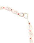 Baroque white freshwater pearl Ruthie B. necklace with coral-hued silk and silver clasp by Hannah Blount