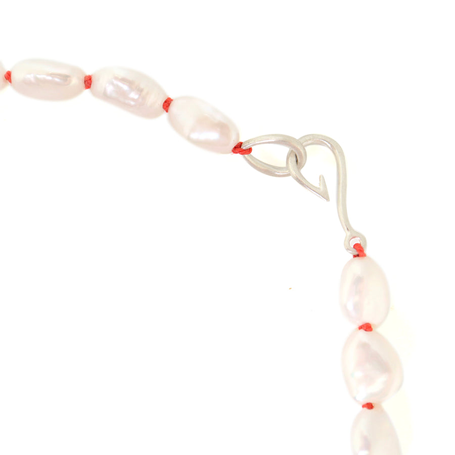 Baroque white freshwater pearl Ruthie B. necklace with coral-hued silk and silver clasp by Hannah Blount